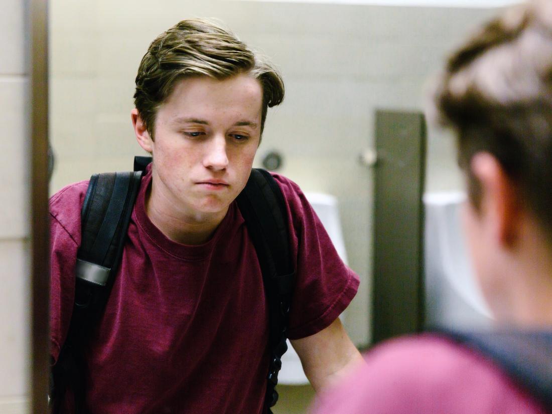 a-teen-with-depression-looking-sad-in-the-mirror a-teen-with-depression-looking-sad-in-the-mirror